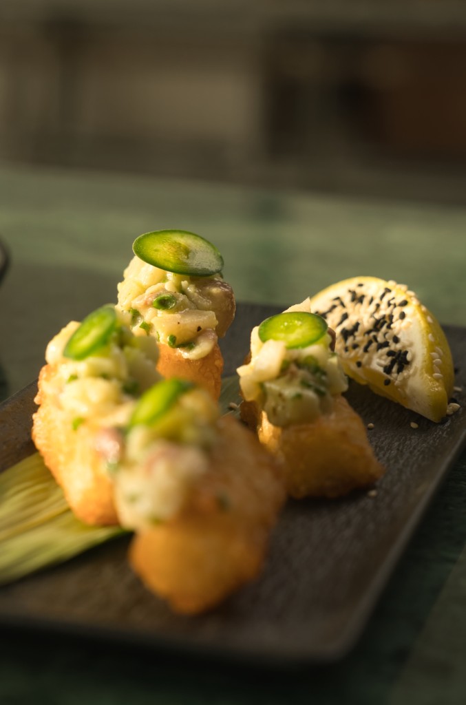 Crispy rice canapés in a line — shallow depth of field